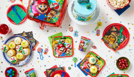 Tabletop with Mario Brothers-themed party favours, décor, and tableware.
