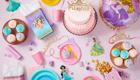 Tabletop with Disney Princess-themed party favours, décor, and tableware.