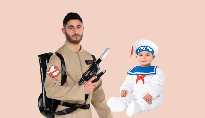 Man wearing a Ghostbuster costume with a toddler wearing a Stay Puft costume.