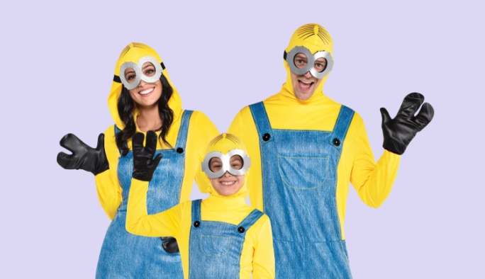  A woman, man, and child wearing minions costumes. 