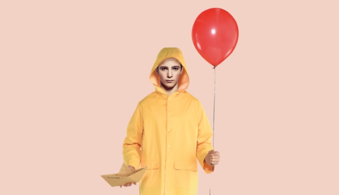 Adult wearing an IT-themed  raincoat costume
