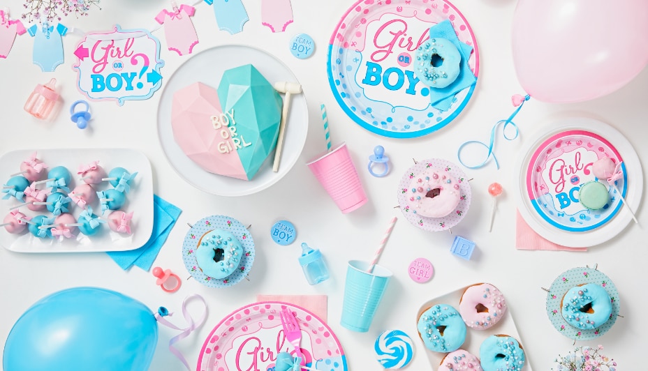 Blue and pink gender reveal tableware and treats.