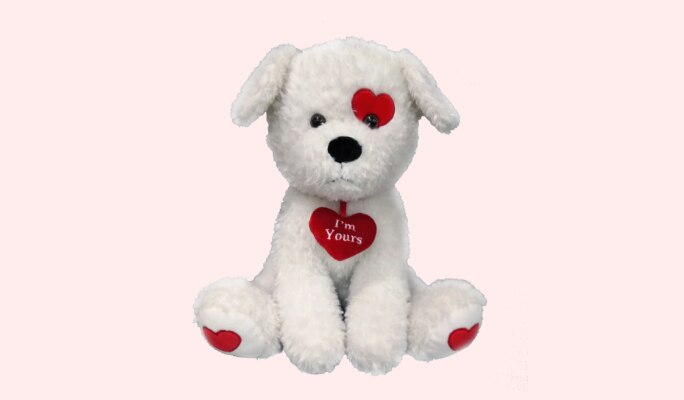 A white plush dog toy with red heart accents including a heart around its neck that reads “I’m Yours” in white text.