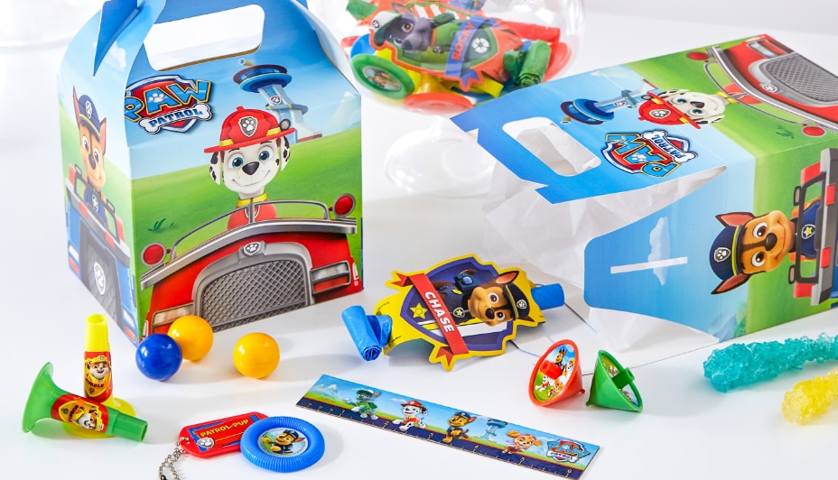 An assortment of multicoloured PAW Patrol-themed party favours including blowouts and favour boxes.