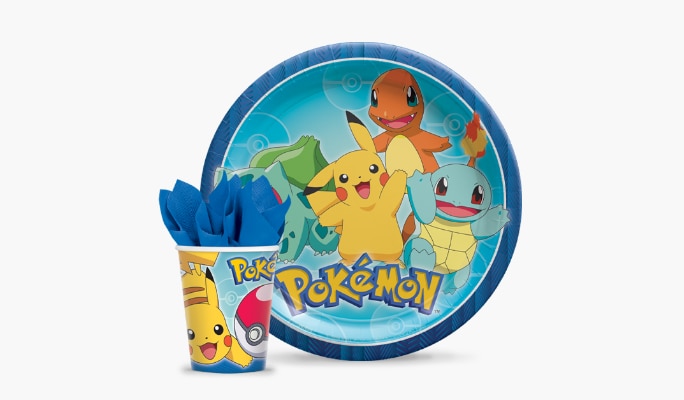A blue and multicoloured classic Pokémon lunch paper plate and matching paper cup with a blue napkin stuffed inside.