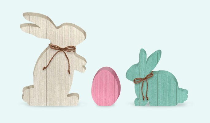 A 3-piece set of Easter MDF standing decorations shaped like bunnies and an egg. 