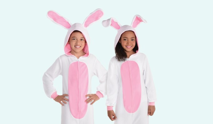 Two children wearing white and pink child bunny zipster costumes.
