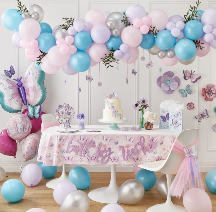 A room filled with pastel coloured butterfly-themed décor including a Flutter 5-pc balloon bouquet and floral paper wall decorations.