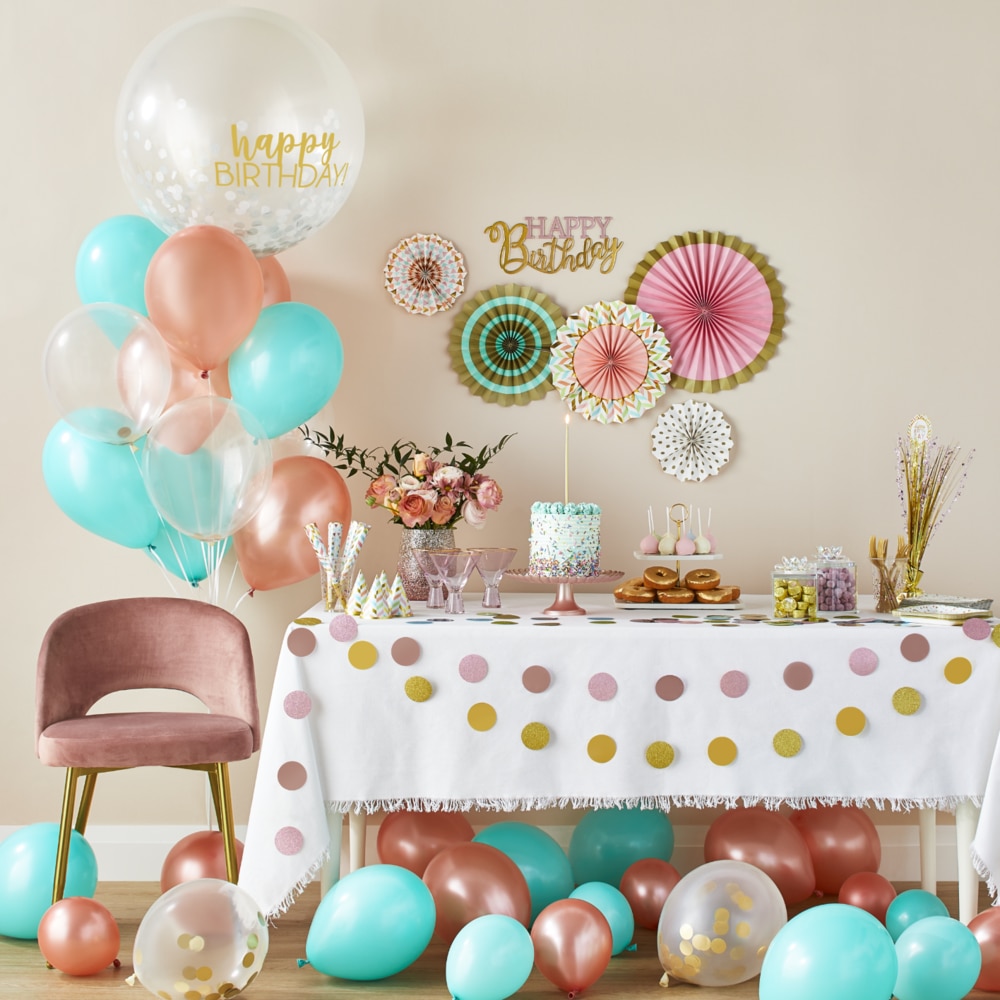 A room styled with a Cosmic Pearl balloon garland kit and Shimmering Mermaids balloons, décor and party supplies.