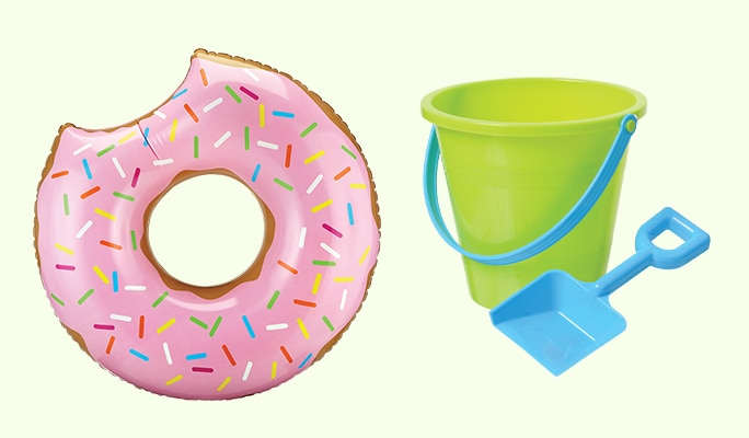 A pink 48-inch inflatable donut pool swim ring and a green toy pail with a blue shovel.