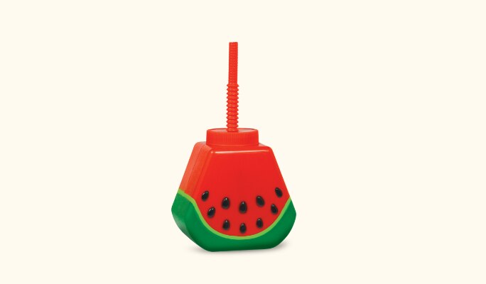 A bright red and green plastic watermelon cup with straw.