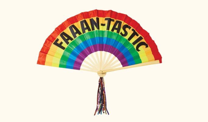 A Pride rainbow handheld fan with a “faaan-tastic” print and a beaded tassel.