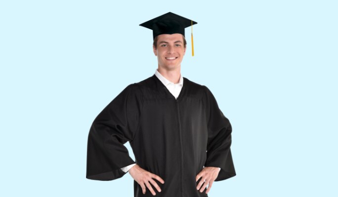 A young man wearing a black adult graduation gown and cap.