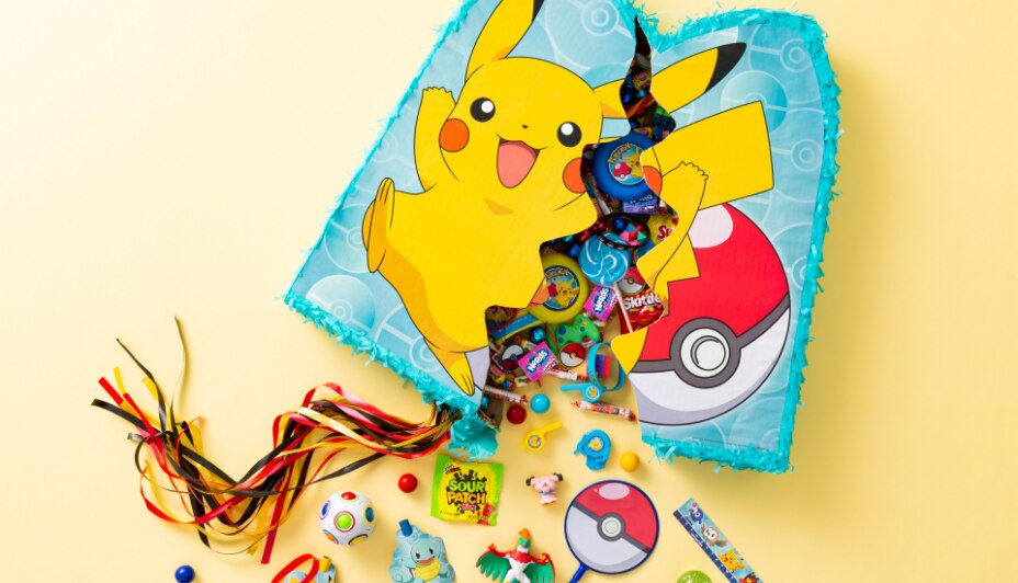 Candy and toys spilling out of a split open Pikachu pull string piñata.