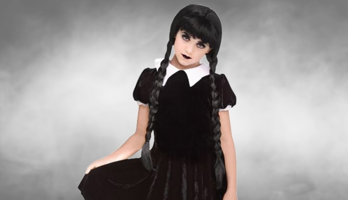 A girl wearing a black and white Gothic Girl Panne Dress costume.