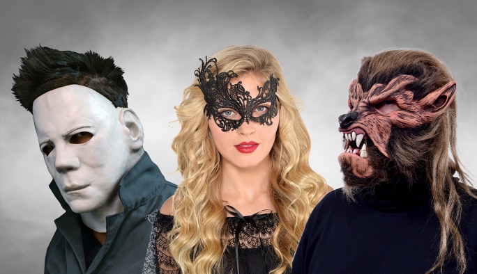 Two men wearing horror masks and a woman wearing a masquerade mask.