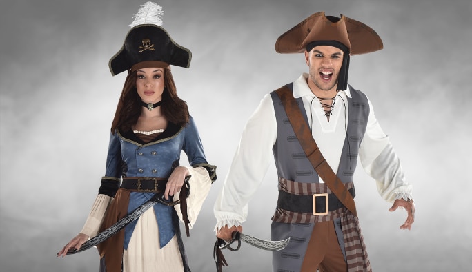 A man and a woman wearing pirate costumes and accessories.