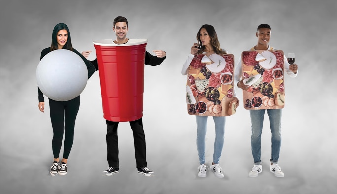 A couple wearing a Beer Pong couples’ costumes and couple wearing matching charcuterie board costumes.