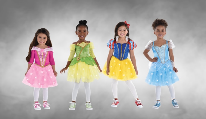Four girls wearing assorted light-up Disney Princess character costumes.