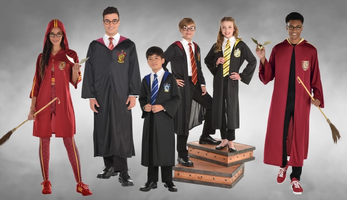 Three adults and three kids wearing assorted Harry Potter character costumes and accessories.
