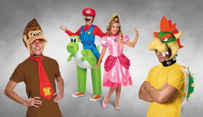 Two adults and two kids wearing assorted Super Mario character costumes.