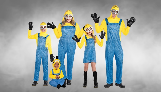 Two kids, a baby and two adults wearing matching Minions costumes and accessories.