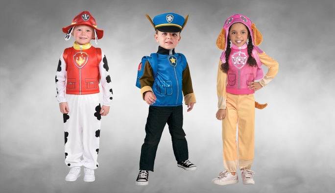 Three children wearing PAW Patrol Marshall, Chase and Skye character costumes.