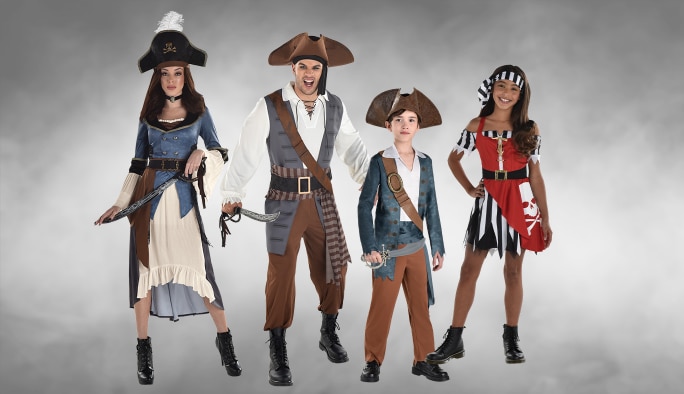 Two adults and two children wearing assorted pirate costumes and accessories.