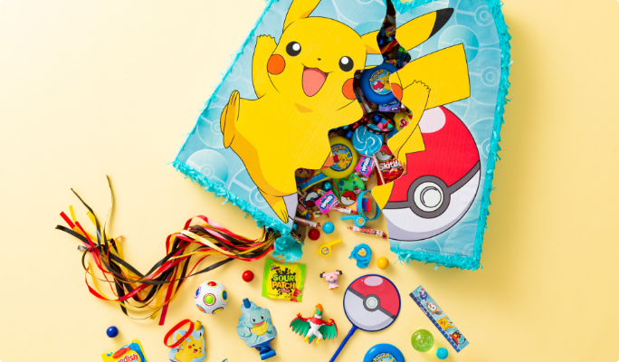 Candy and toys spilling out of a split open Pikachu pull string piñata.