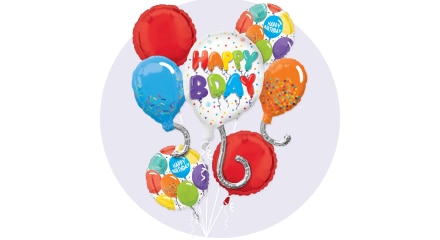 Several multi-coloured balloons surrounding a white balloon that says 'Happy Birthday'.