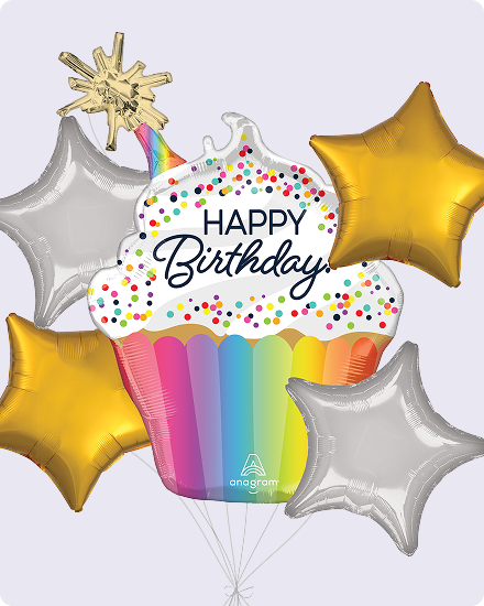 An inflatable multi-coloured cupcake balloon with the words 'Happy Birthday written on it' surrounded by silver and gold star-shaped balloons.
