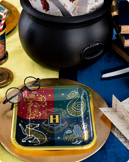 A table decorated with green and brown Minecraft themed tableware and snacks.