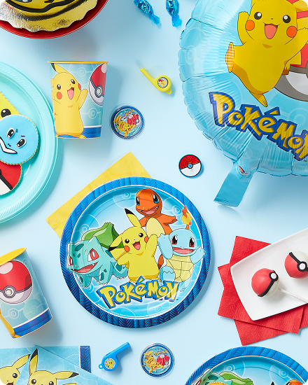 A table decorated with Pokemon themed plates, napkins, cups and balloons.