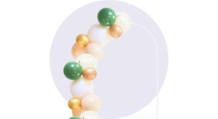 Une guirlande de ballons blancs, pêches et verts.