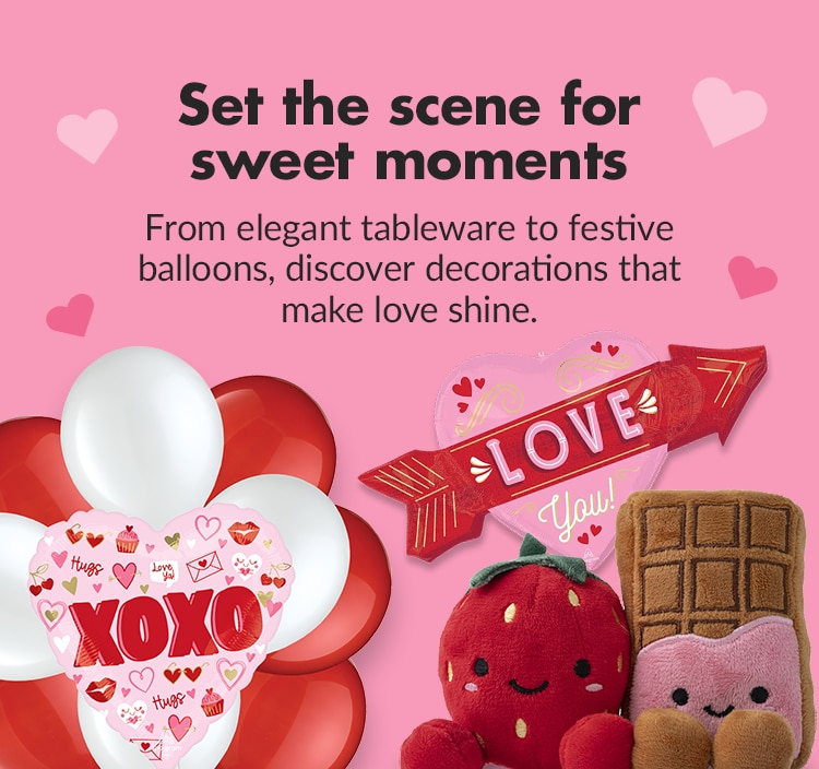 A pink banner with an inflatable teddy bear balloon, various heart-shaped decorations, balloons and Valentine's-themed tableware and serveware. 
