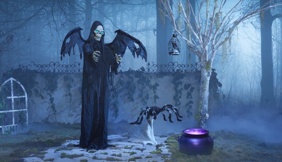 A 6-ft Grim Reaper animated led light-up standing decoration in a fog-filled yard.