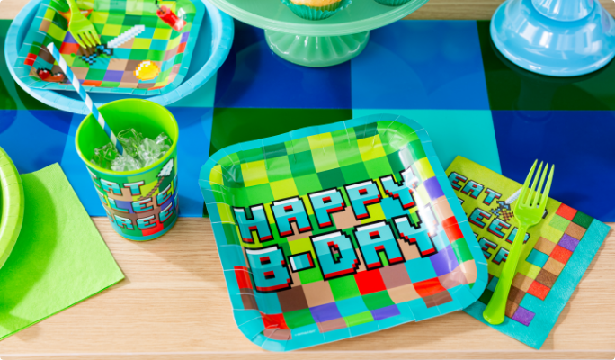 Pixel Party plates and tableware with a blue and black table runner.