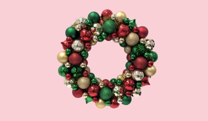 A red, green and gold Christmas ornament wreath.