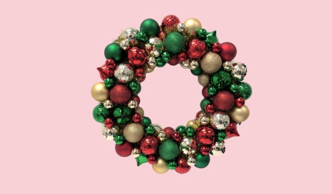 A red, green and gold Christmas ornament wreath.