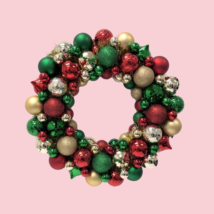 A red, green and gold Christmas ornament wreath.