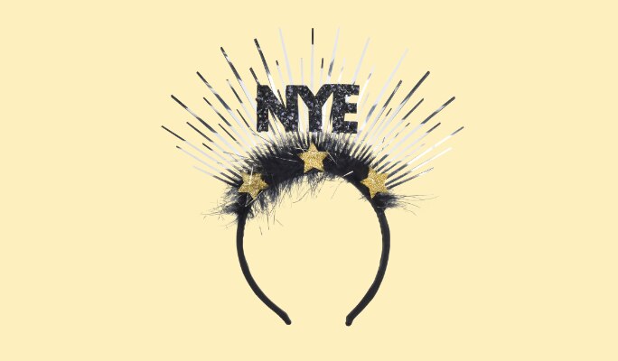 A decorative black, white and gold headband with the word NYE.