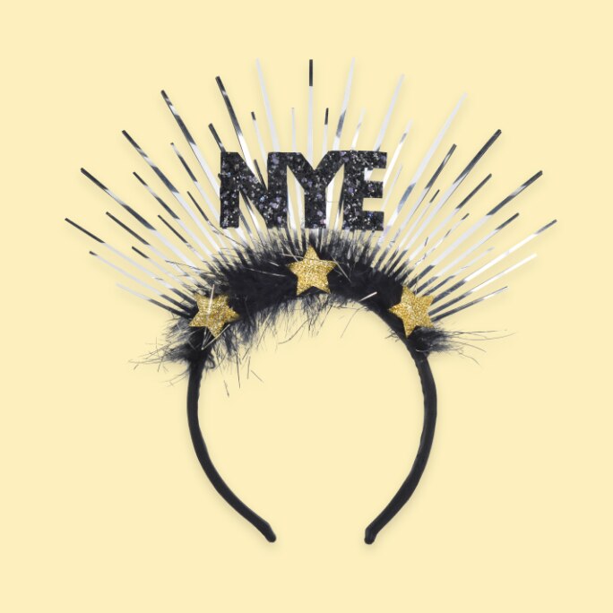 A decorative black, white and gold headband with the word NYE.