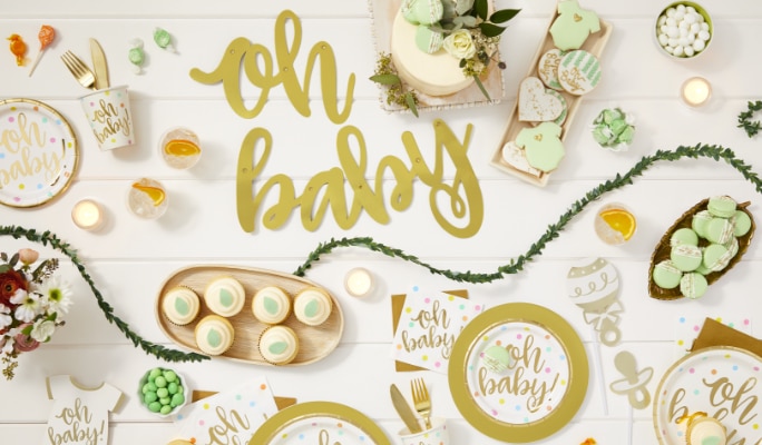 Various Oh Baby-themed decor and tableware on a white backdrop.