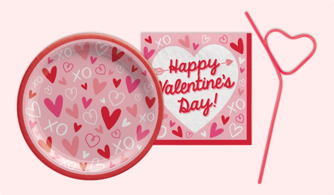 A round plate and napkin featuring a heart pattern and a heart-shaped silly straw.