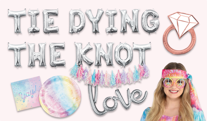 Silver letter balloons that read TIE DYING THE KNOT and LOVE, a giant rose gold engagement ring balloon, a woman wearing peace sign-shaped glasses and a tie-dye bandana, a multi-coloured tassel garland and a tie-dye plate and a tie-dye napkin.