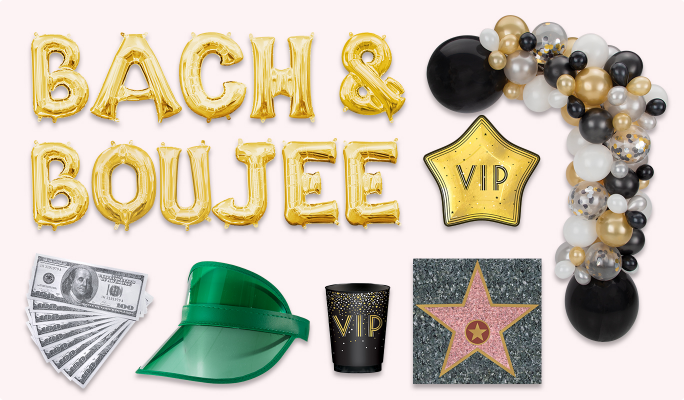 Gold letter balloons that read BACH & BOUJEE, a balloon garland with black, gold, silver and white balloons, a gold VIP star-shaped plate, a Hollywood Walk of Frame star sticker, a stack of fake American dollars, a green visor hat and black and gold tumbler.