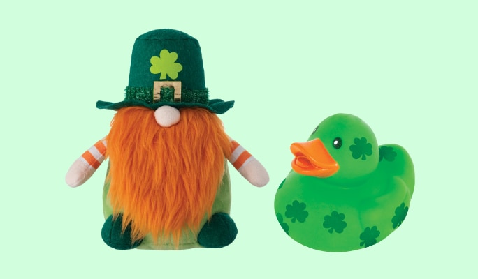 A green rubber duck with a shamrock pattern and a St. Patrick's Day-themed gnome.