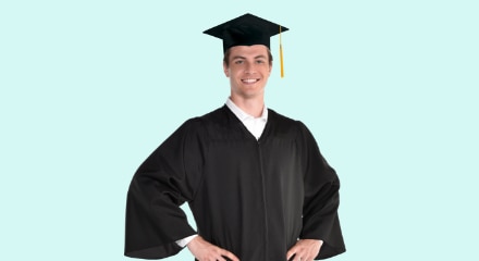 A young man wearing a standard black adult graduation gown and graduation cap with a tassel. 