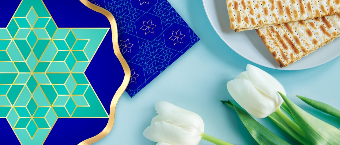 A table decorated with a Passover-themed plate and napkin.