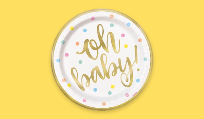 A white and polka dot plate that reads "Oh baby!"